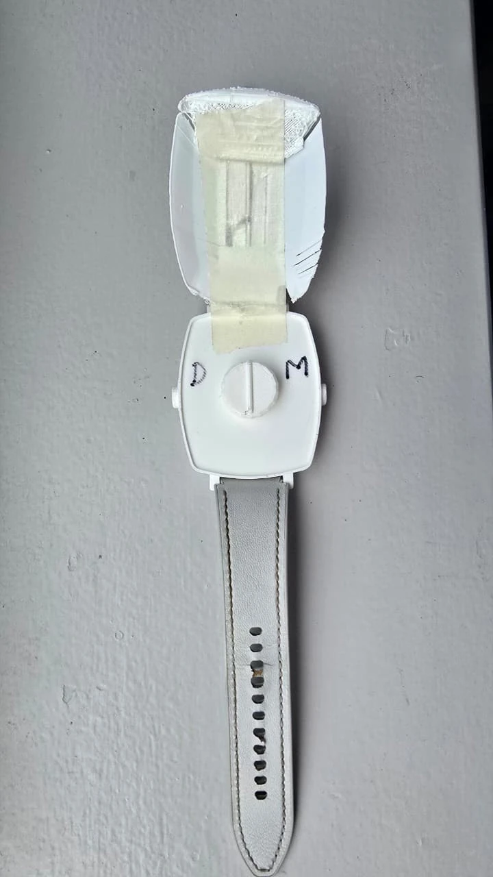 White Signal Core 3D-printed wrist model with its lid open and D/M markings beside the dial.